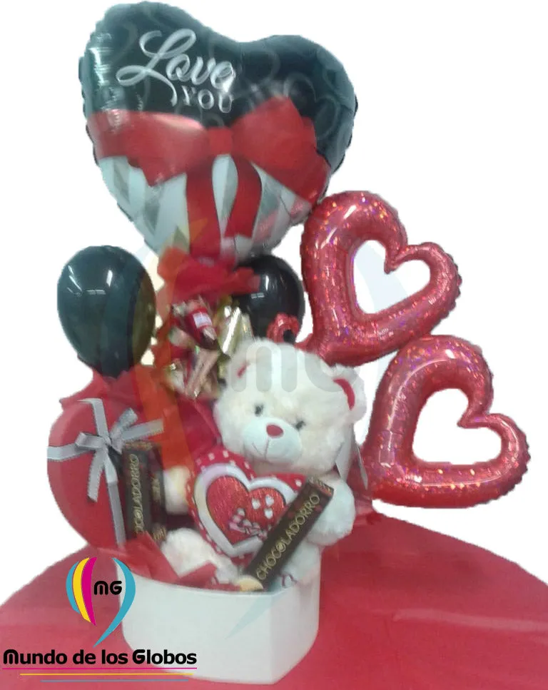 Adorno para mesa: Peluche Caja de Corazón & Lazo con Peluche Osito Teddy c/ corazón "Love you" Corazón de 18"  Lazo "I love You", Siluetas de Corazón Rojo holografíco de 14" pulgs. y látex de 5" pulgs. negros.